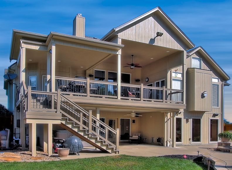 A large house with a large deck and stairs