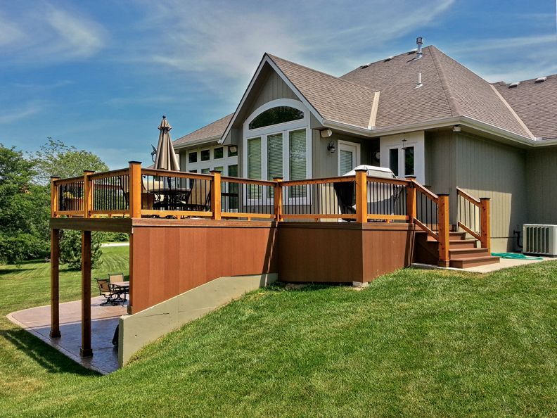 A large house with a large deck and stairs