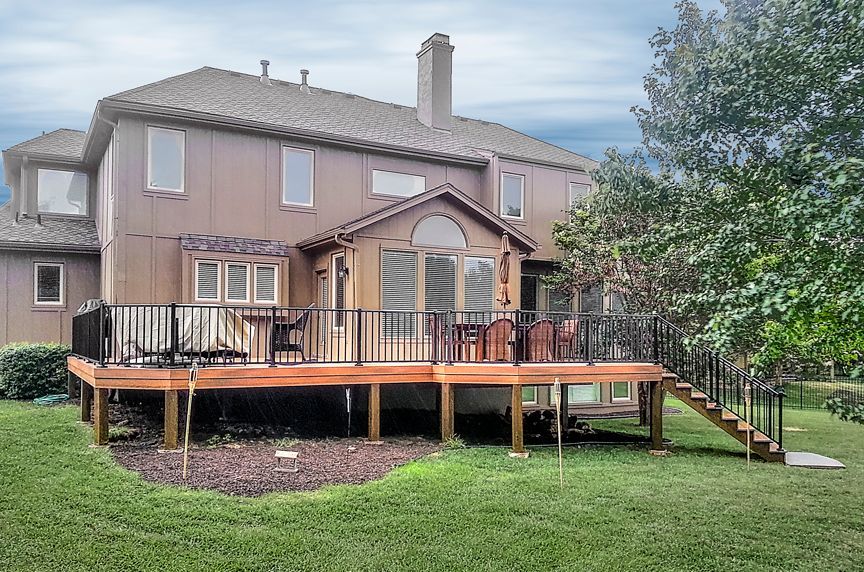 A large house with a large deck in front of it.