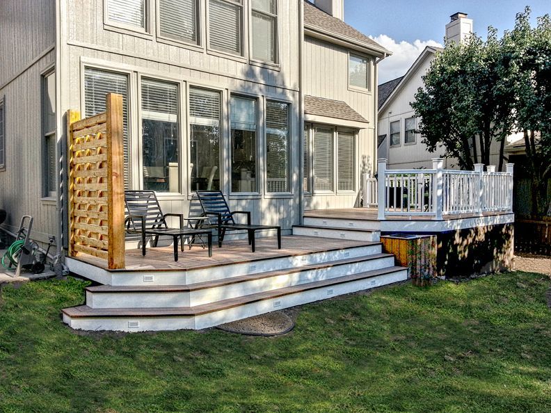 A large house with a large deck in front of it.