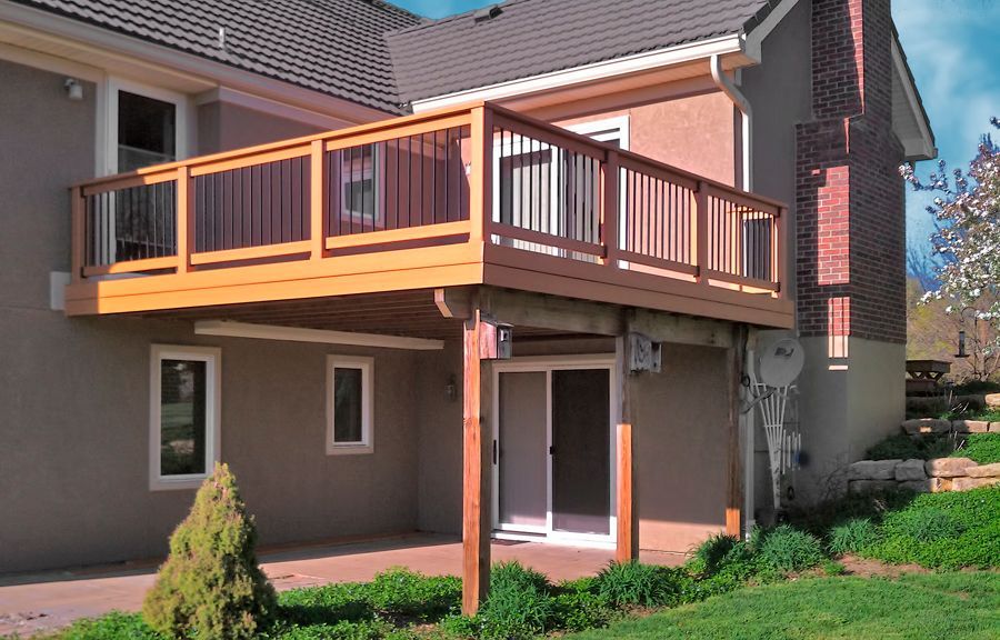 A house with a wooden deck and a sliding glass door