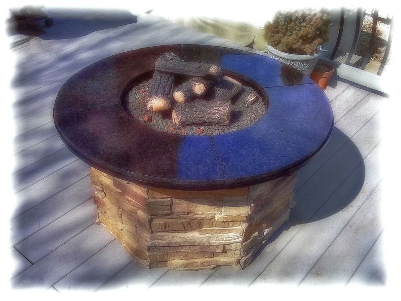 A fire pit is sitting on a wooden deck