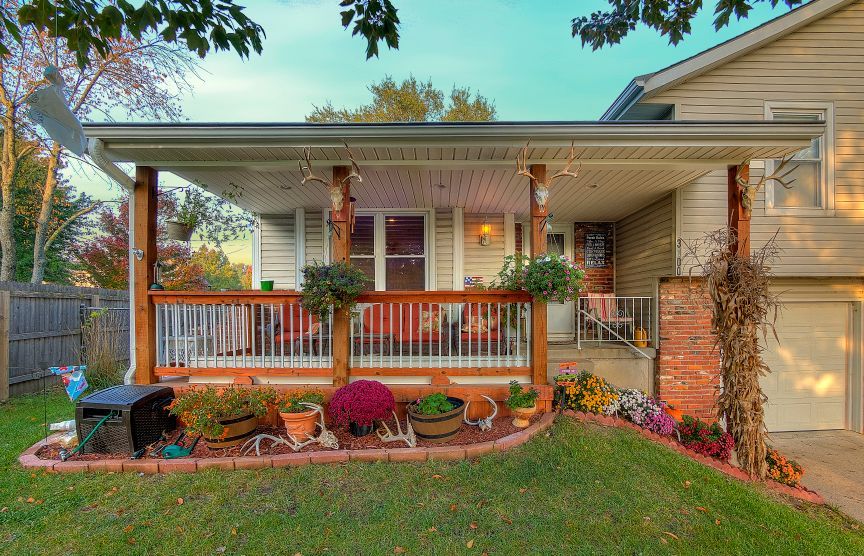 A house with a large porch and a garage