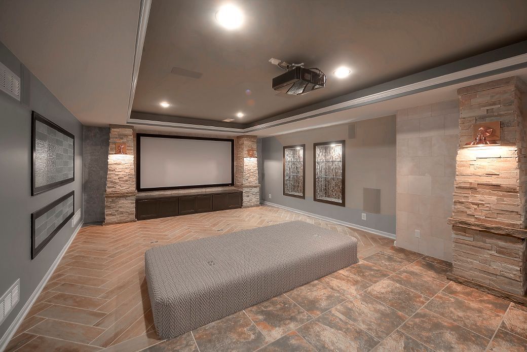 A home theater with a large screen and a projector.