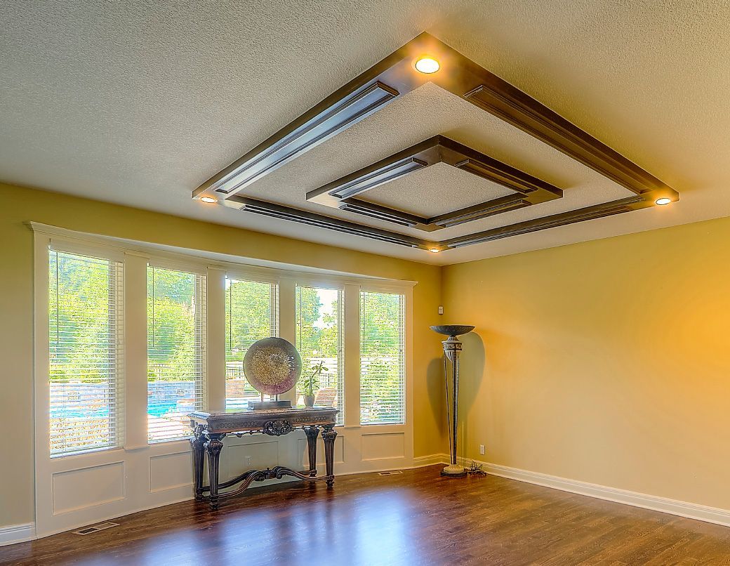 A living room with hardwood floors and a ceiling that has a square design.