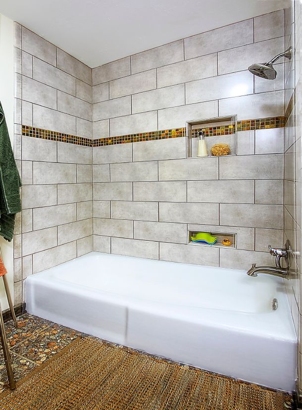 A bathroom with a bathtub and a shower.