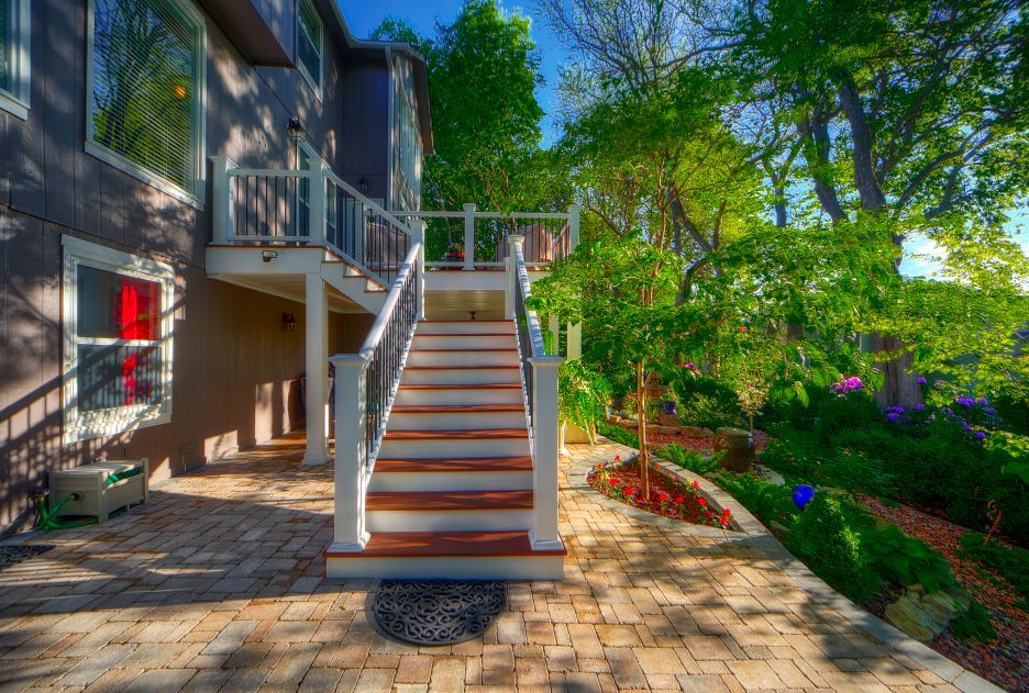 A house with a deck and stairs leading up to it