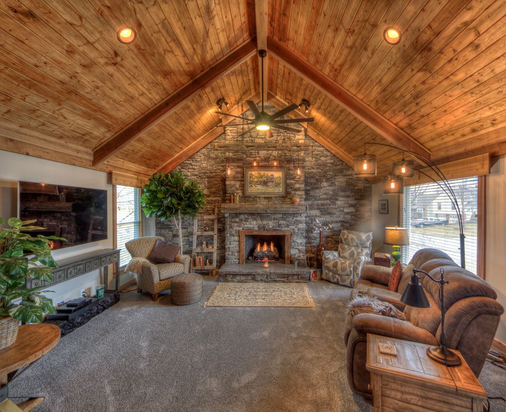 There is a fireplace in the middle of the living room.