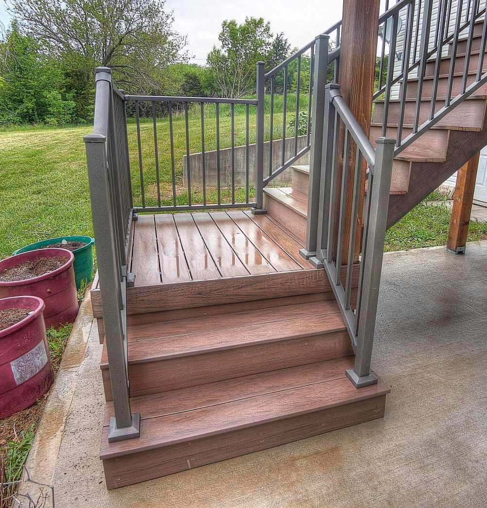 A set of stairs with a wrought iron railing