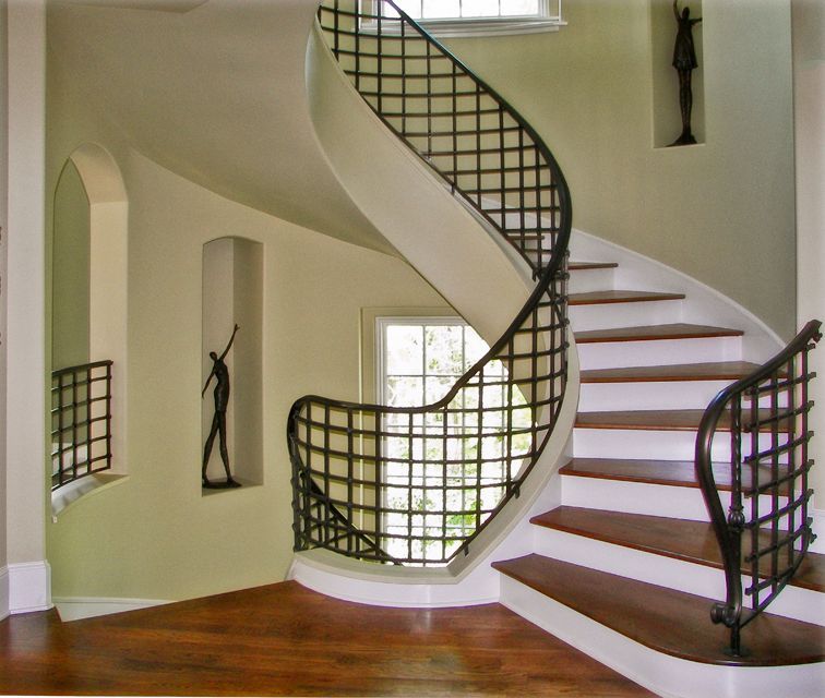 A spiral staircase with a wrought iron railing