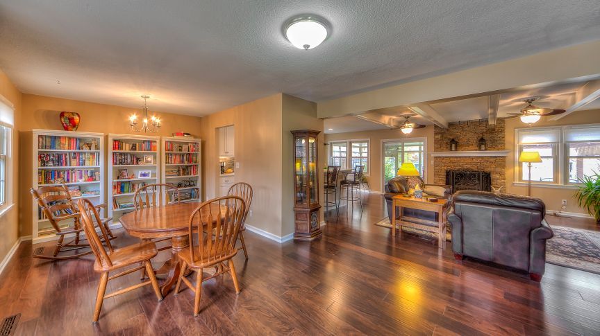 There is a table and chairs in the middle of the room.
