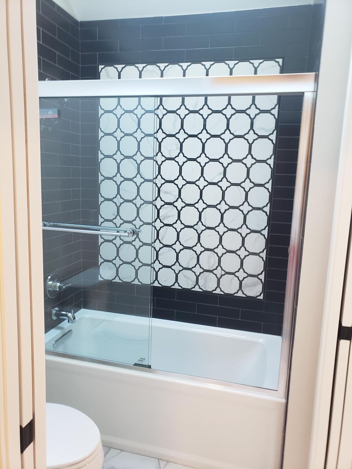 A bathroom with a bathtub and a toilet