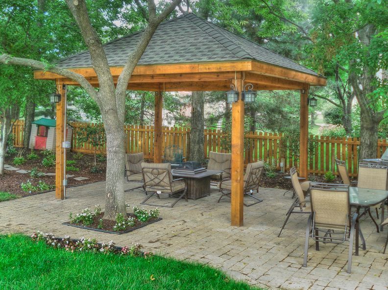 There is a gazebo with a table and chairs underneath it.