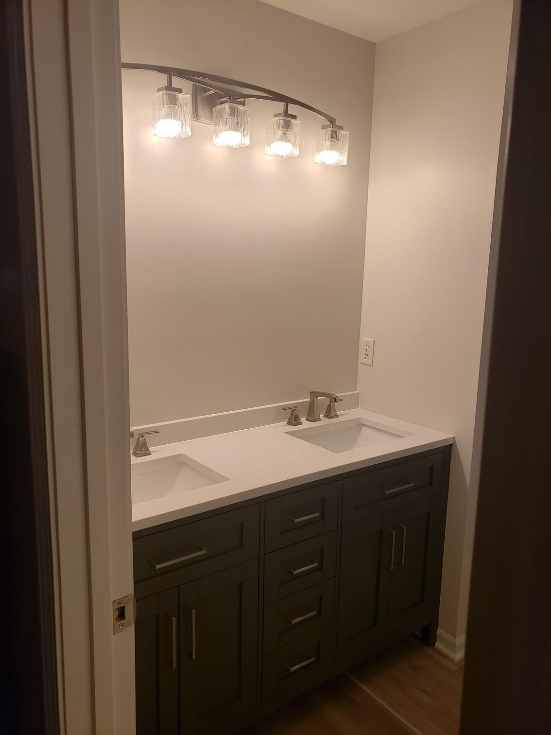 A bathroom with two sinks and a mirror.