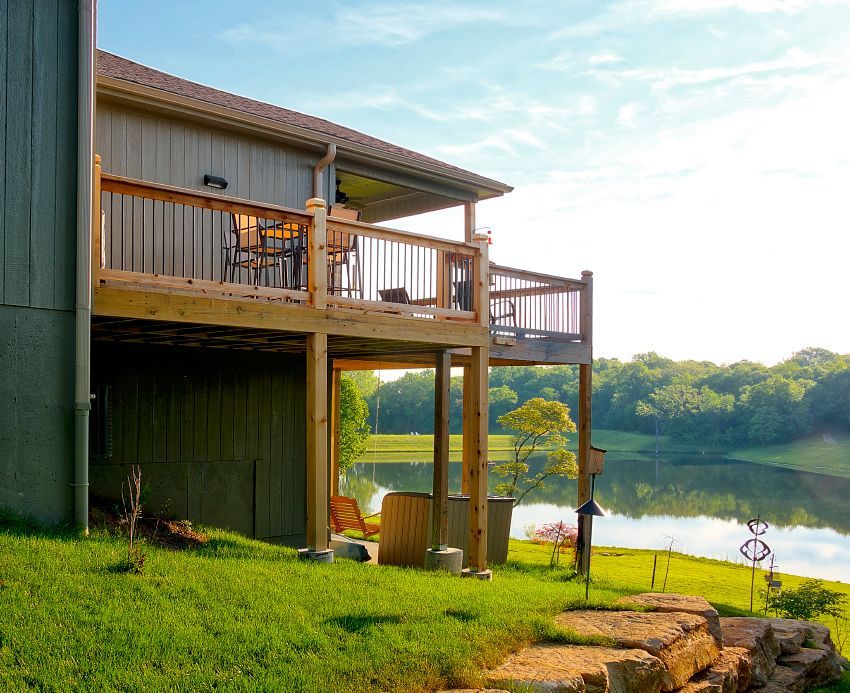 A house with a large deck overlooking a lake