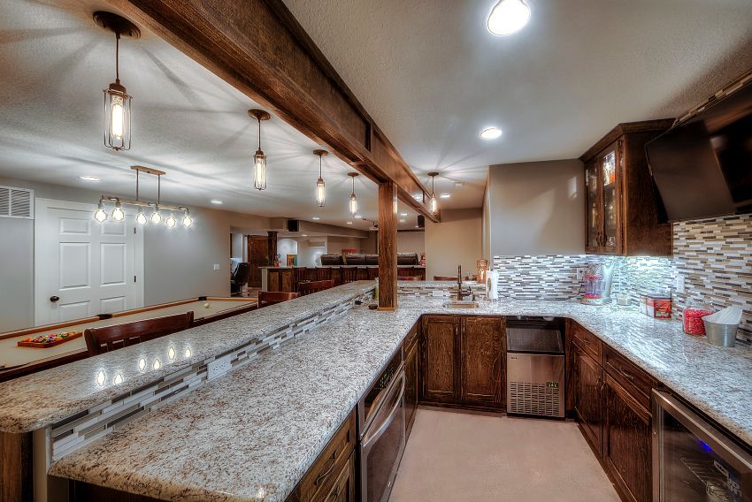 A kitchen with granite counter tops and stainless steel appliances.