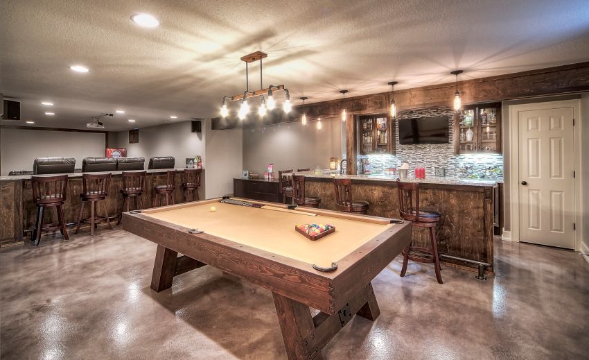 There is a pool table in the middle of the room.