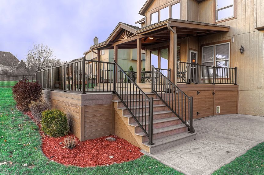 A house with a deck and stairs leading up to it