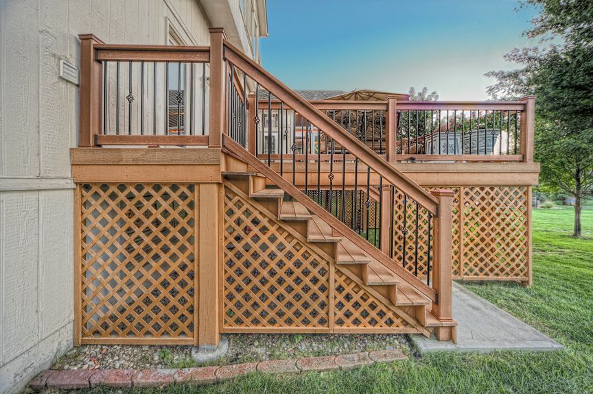 A wooden deck with stairs leading up to it.