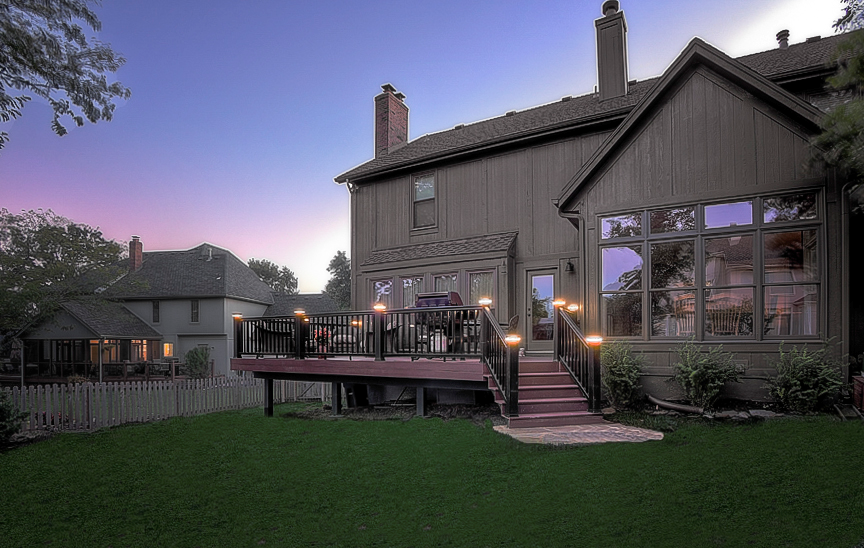 A large house with a large deck and stairs
