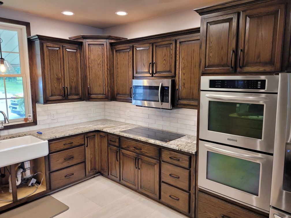 A kitchen with wooden cabinets and stainless steel appliances.