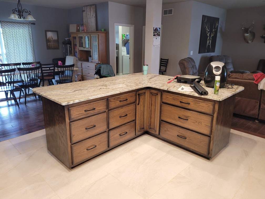 A kitchen with a large island in the middle of the room.
