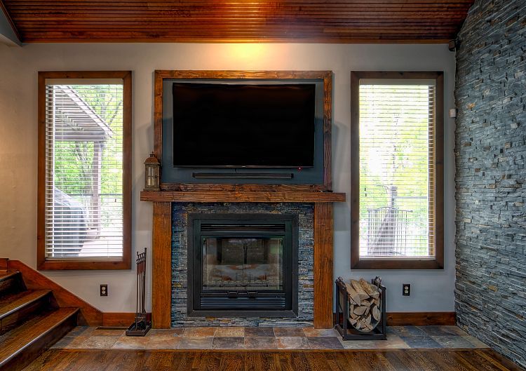 A living room with a fireplace and a flat screen tv.