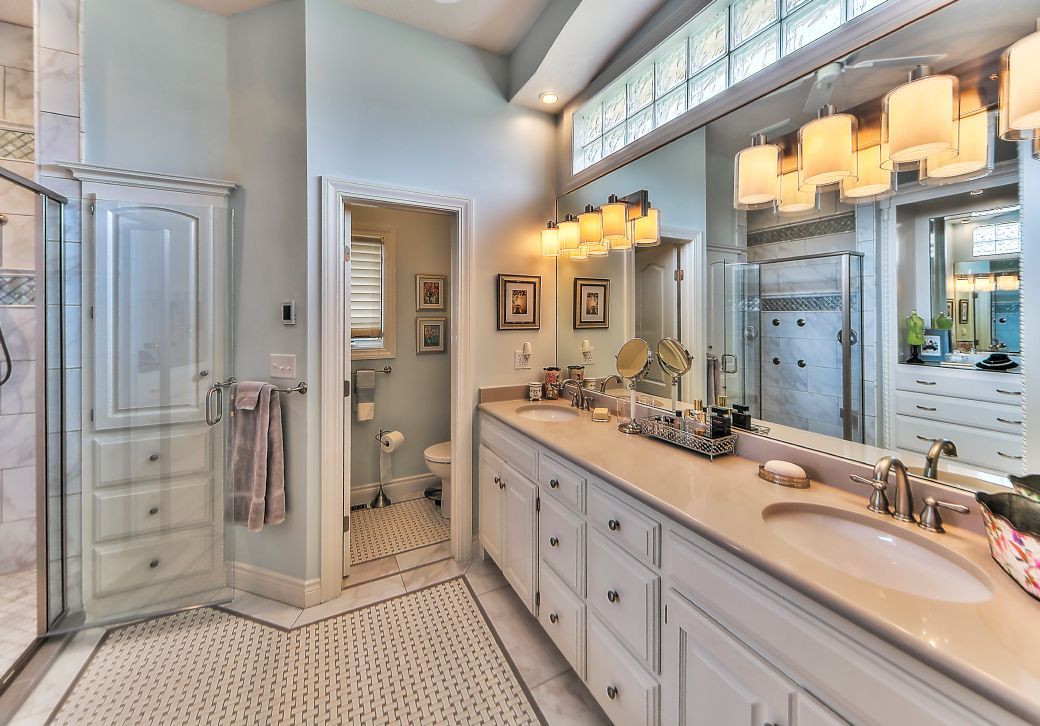A bathroom with two sinks and a large mirror.