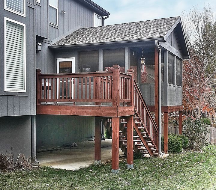 A house with a screened in porch and stairs