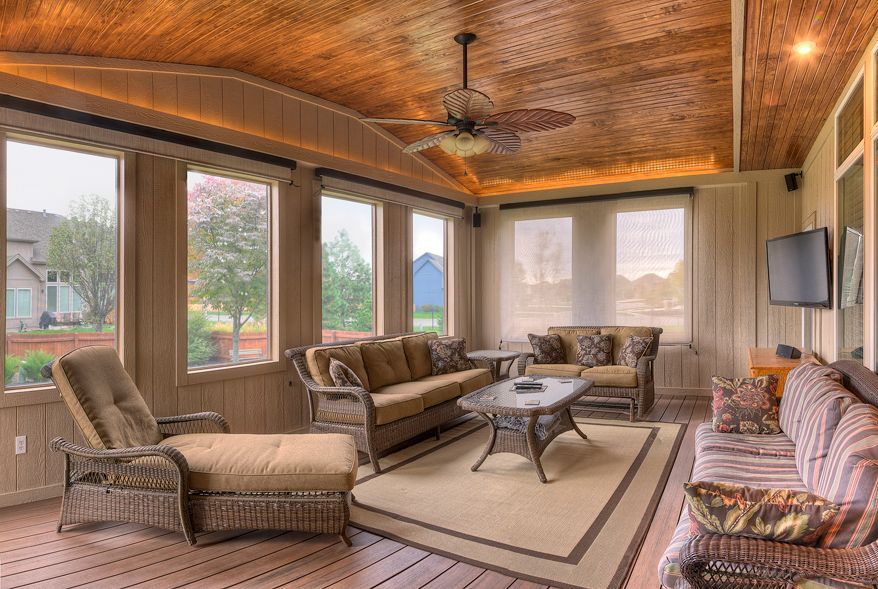A living room with a lot of furniture and a ceiling fan.