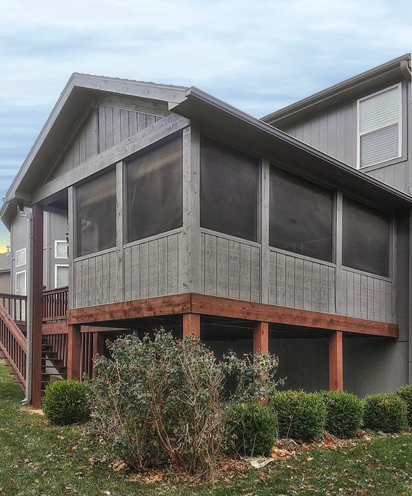A house with a screened in porch and stairs