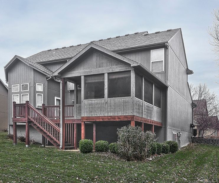 A house with a screened in porch and stairs