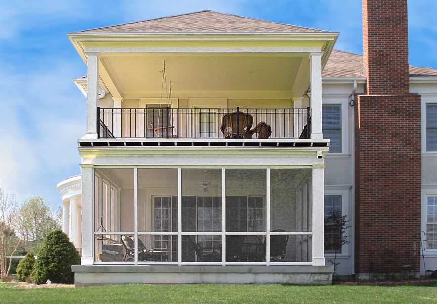 A large house with a screened in porch and a balcony.