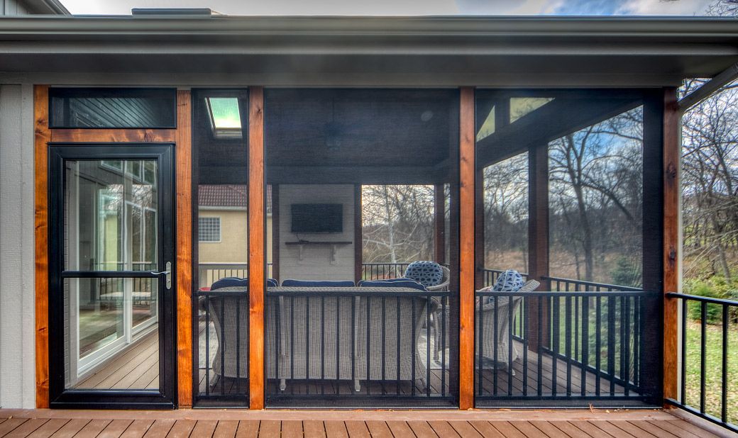 A screened in porch with a tv on the wall