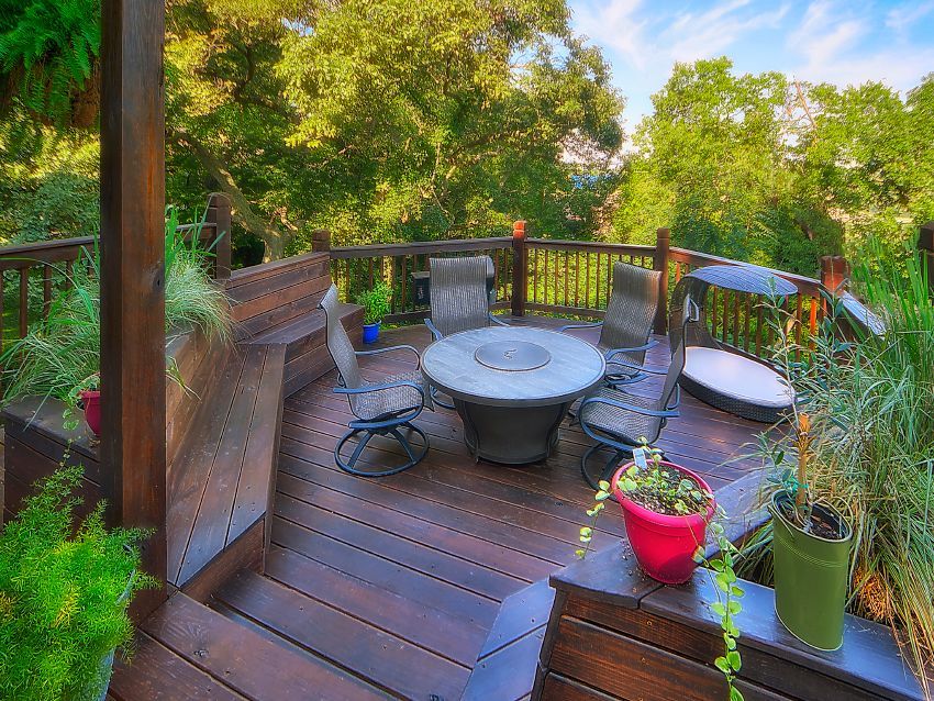 A wooden deck with a table and chairs on it