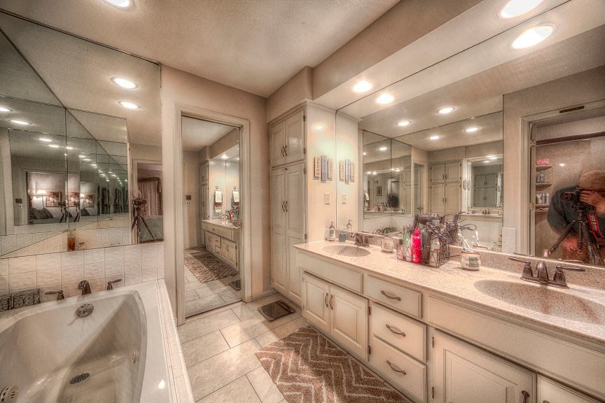 A bathroom with two sinks and a jacuzzi tub.