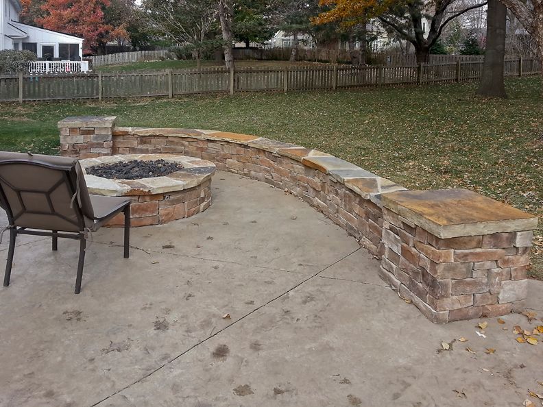 There is a fire pit in the middle of the patio.