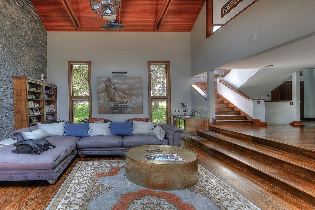 A living room with a couch , coffee table and stairs