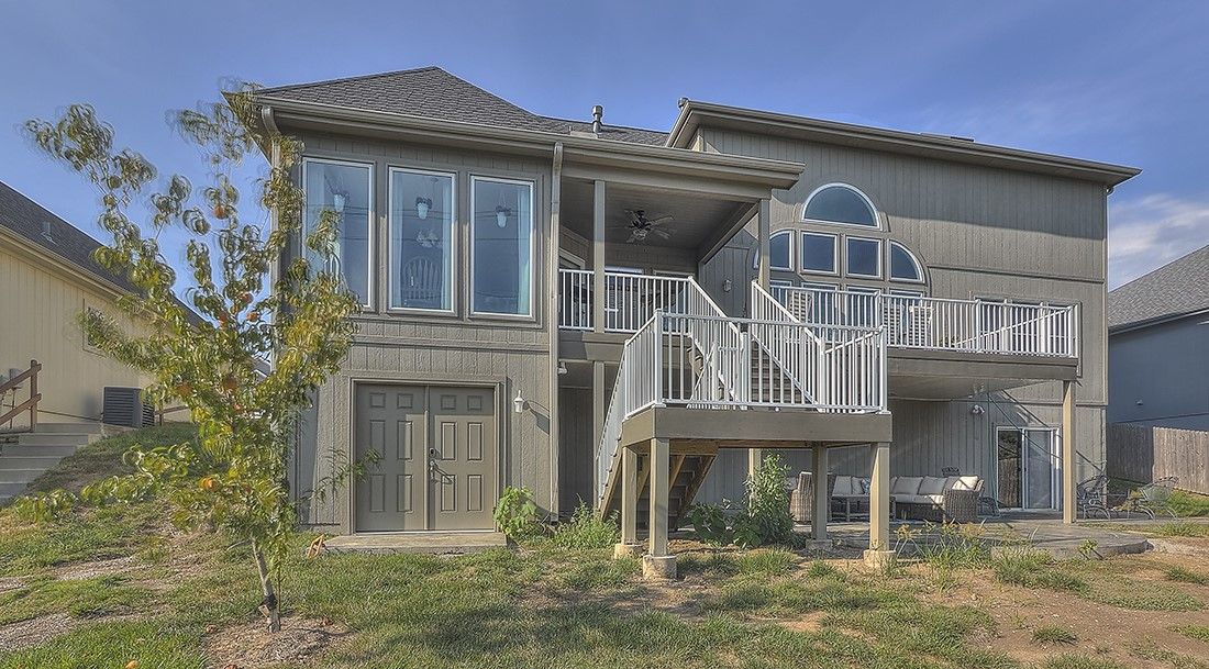 A large house with a lot of windows and a large deck.