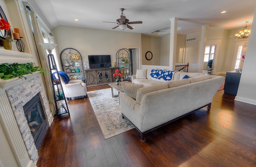 A living room filled with furniture and a fireplace.