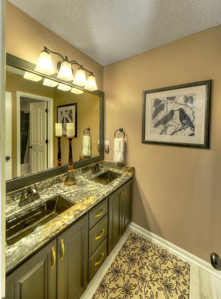 A bathroom with two sinks and a large mirror