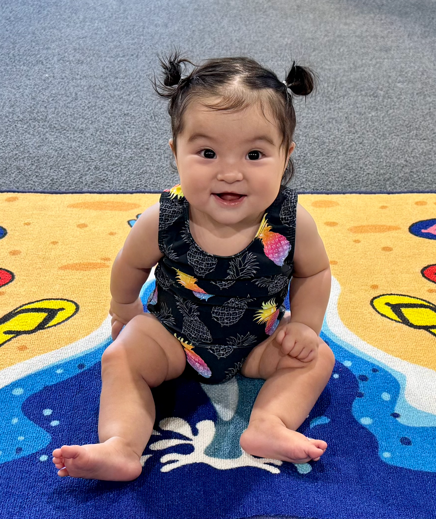 Young girl, in leotard, jumping and smiling