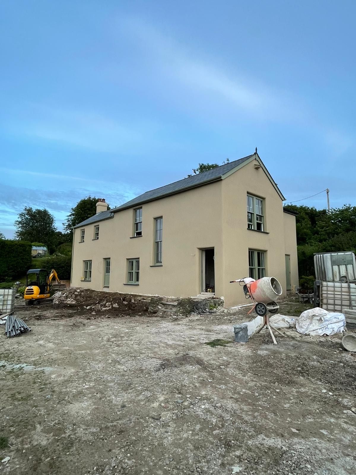 A large brick building is sitting on top of a rocky beach.