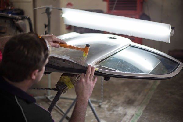 person working on car panel