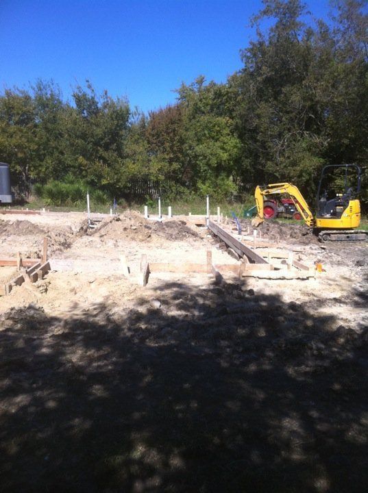 Yellow excavator on a construction site — Corsicana, TX — AKV Plumbing Co