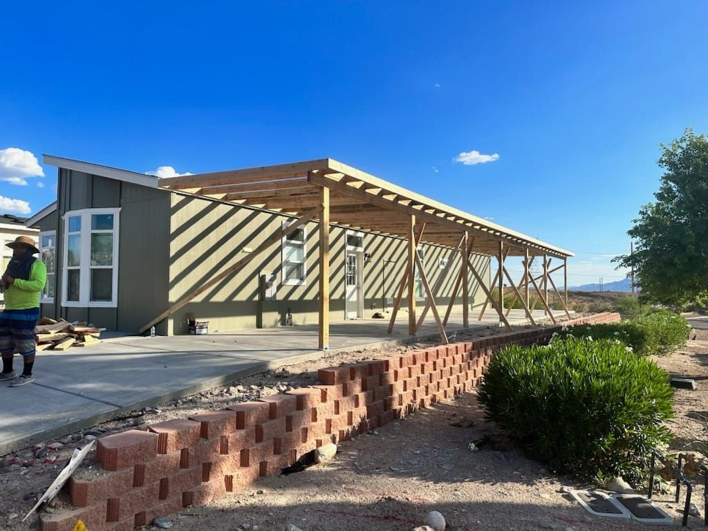 A woman is standing in front of a house under construction.