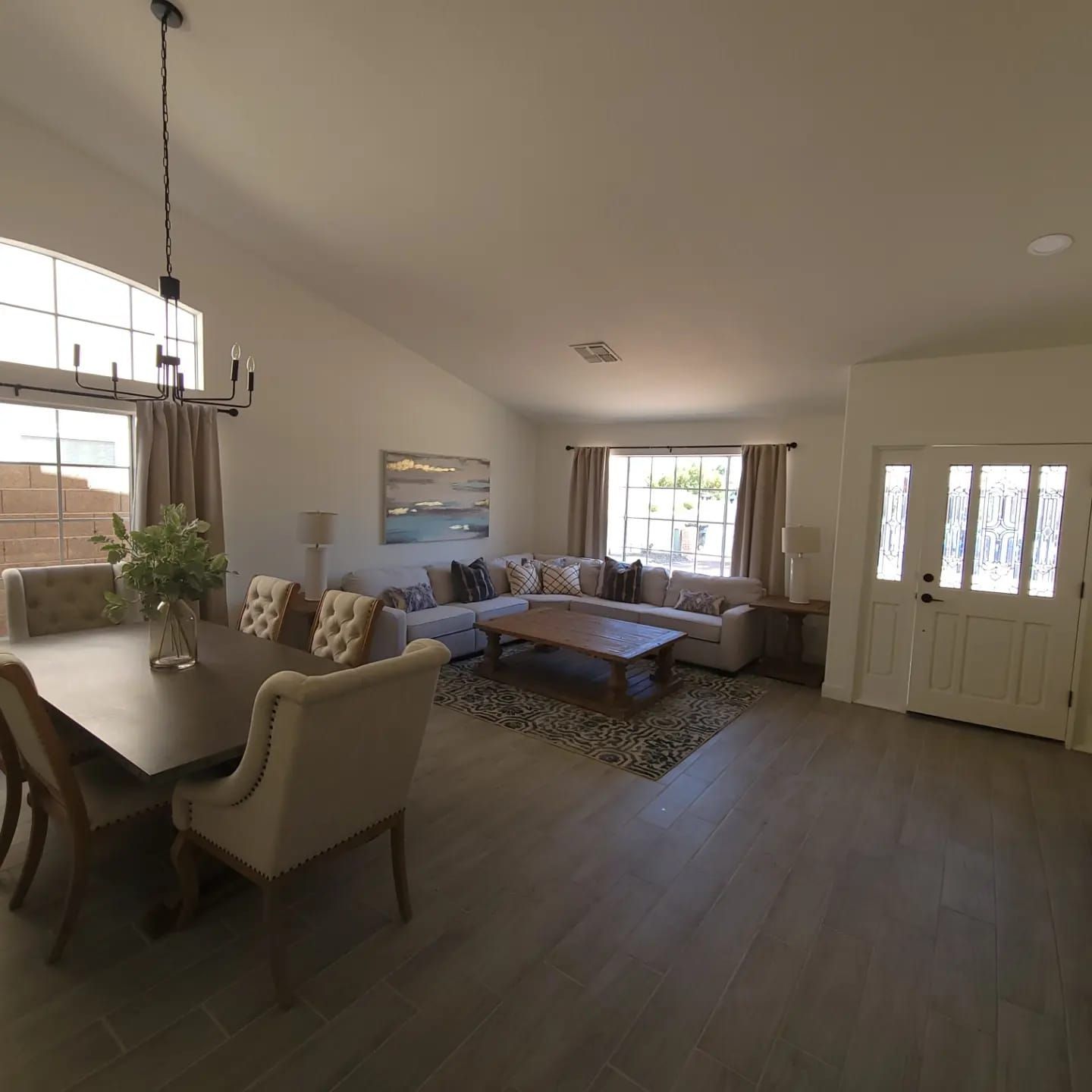 A living room with a couch , table and chairs.