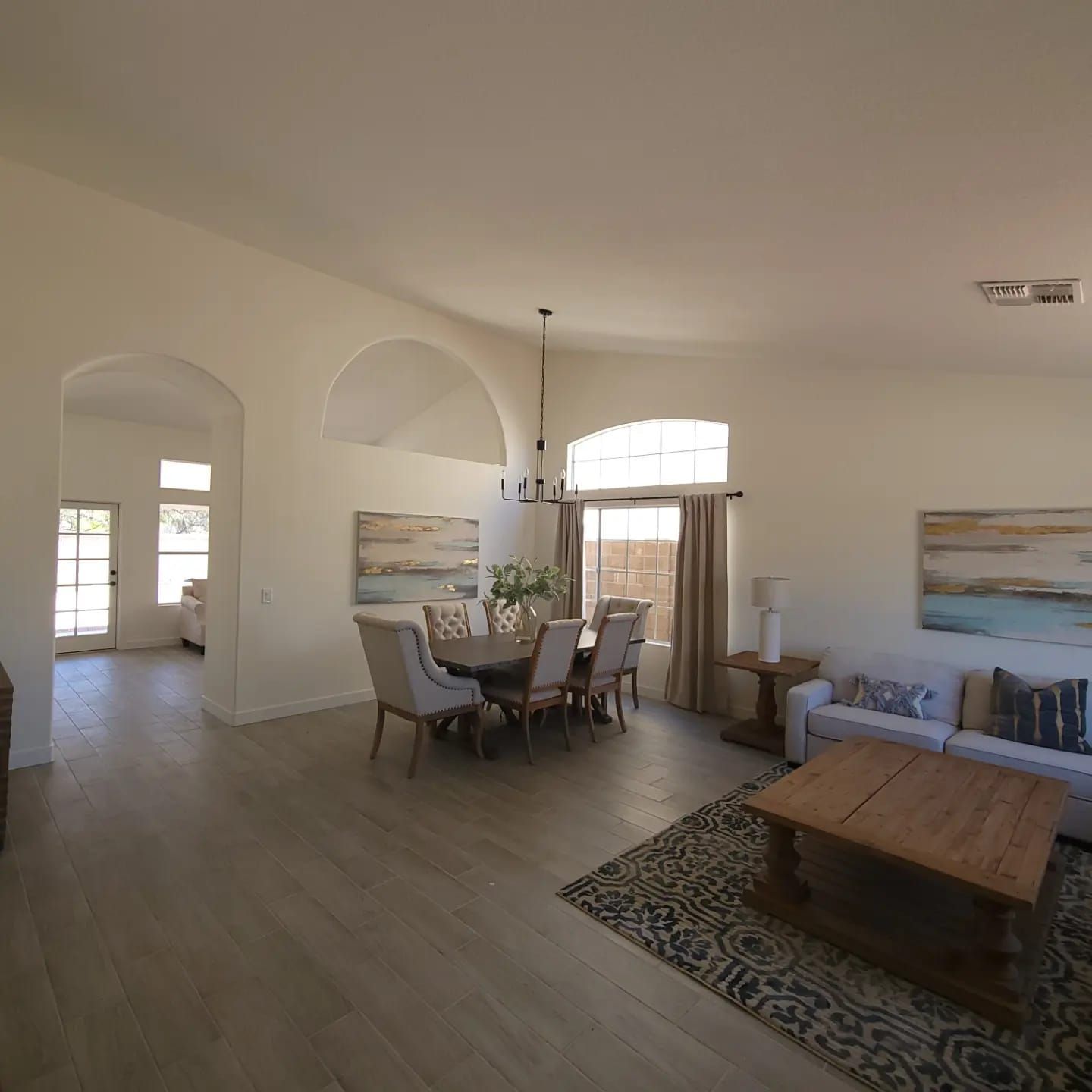 A living room with a dining room table and chairs