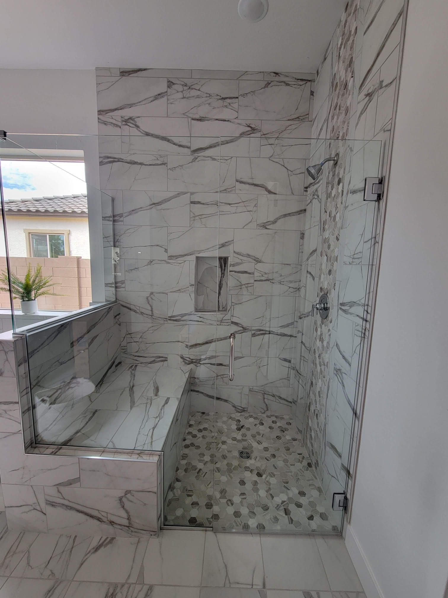 A bathroom with a walk in shower and a bathtub.