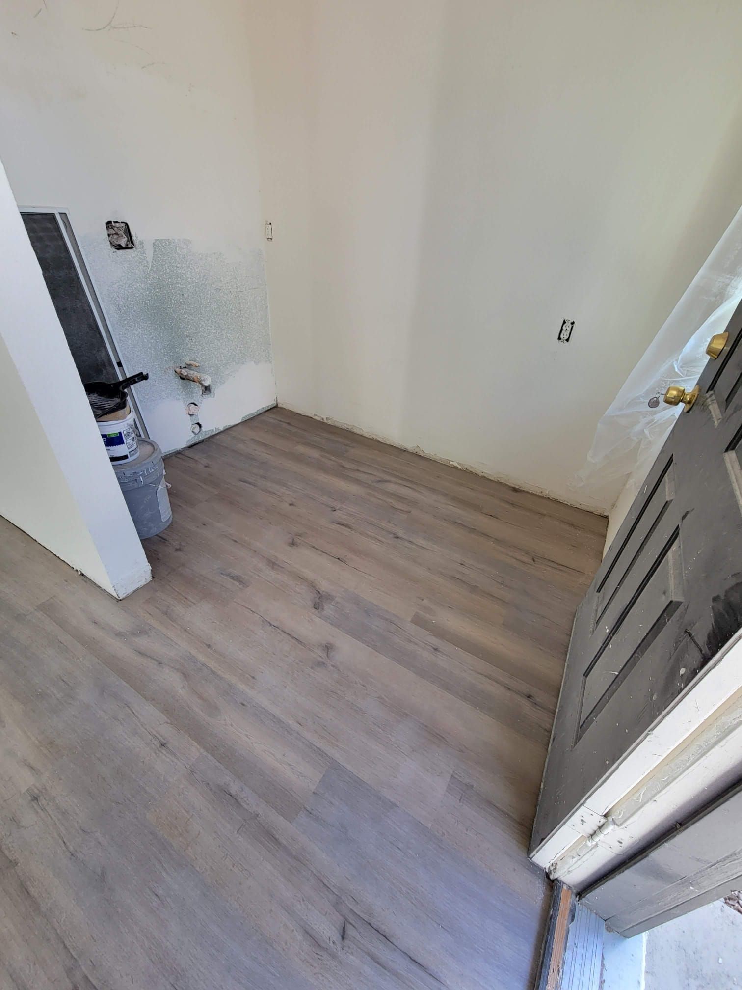 A bathroom with a bathtub and a wooden floor.